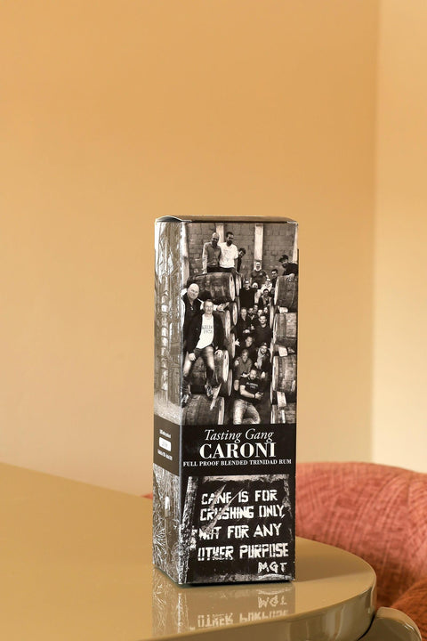 Caroni full proof Trinidad rum bottle featuring a black and white collage of the tasting gang and distillery barrels.